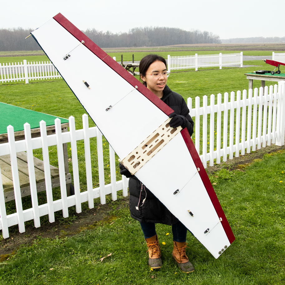 AME senior student holding RC plane before a test flight